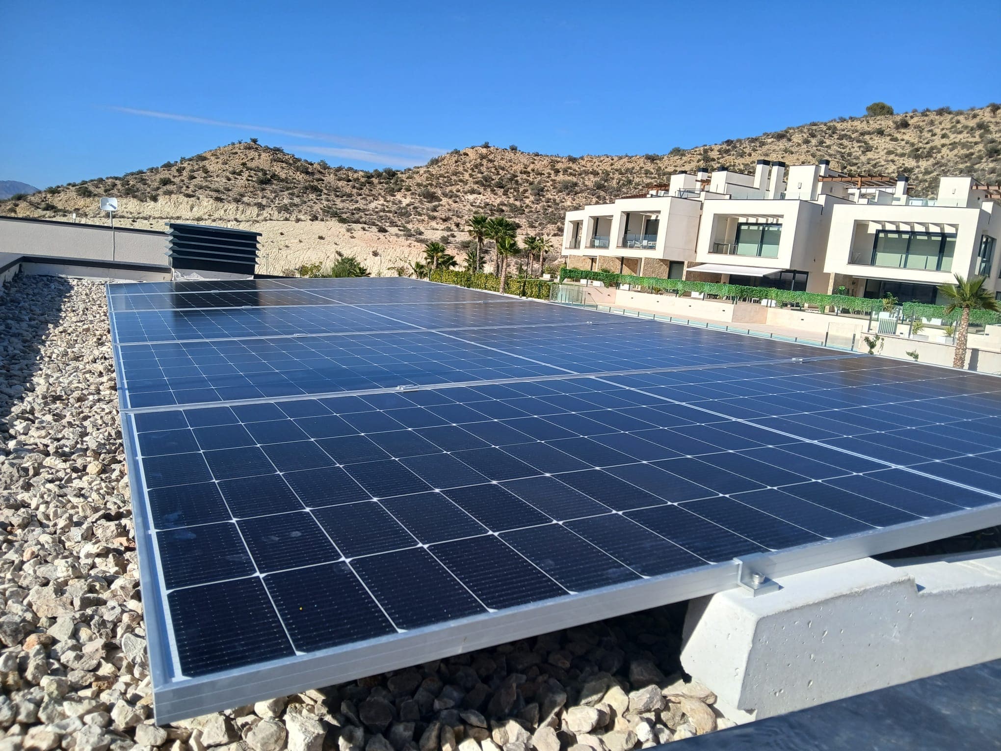 Solar panels on a gravel roof in a new development